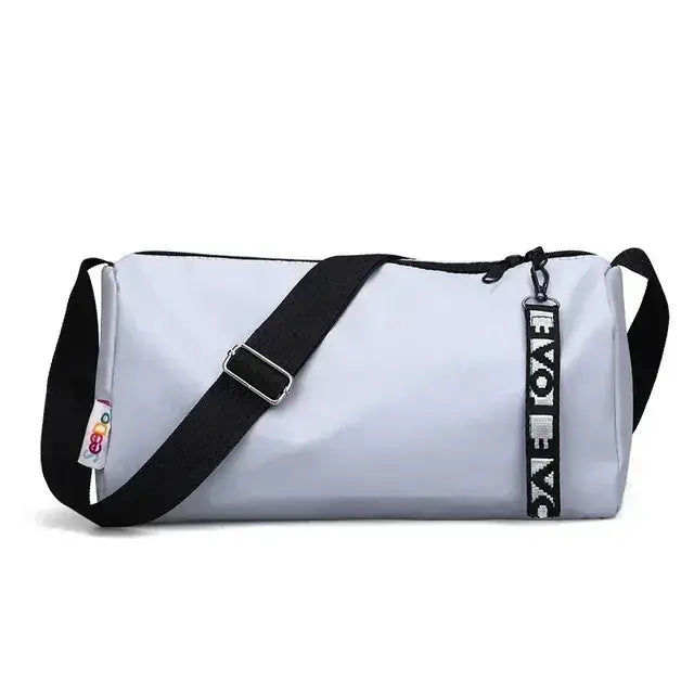 Spacious women's gym fitness training bag in light gray with adjustable strap and stylish branding for organized workouts.