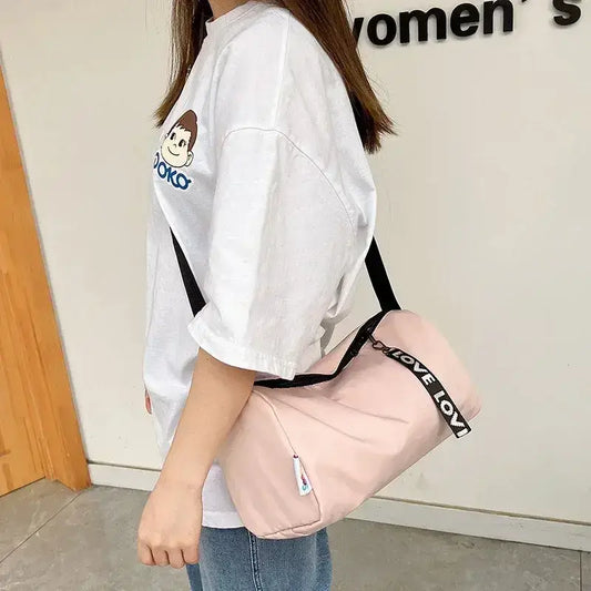 Woman carrying a stylish pink gym fitness training bag, perfect for workouts and organizing gear.